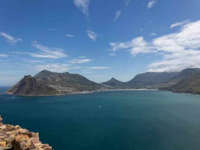 Coastal bay with mountains under open sky
